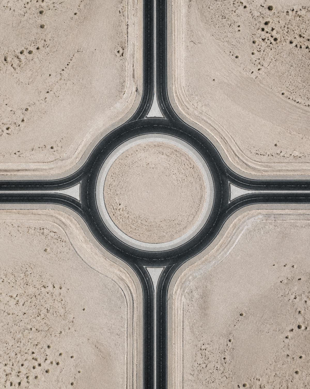 Aerial view of a desert interchange where four roads meet