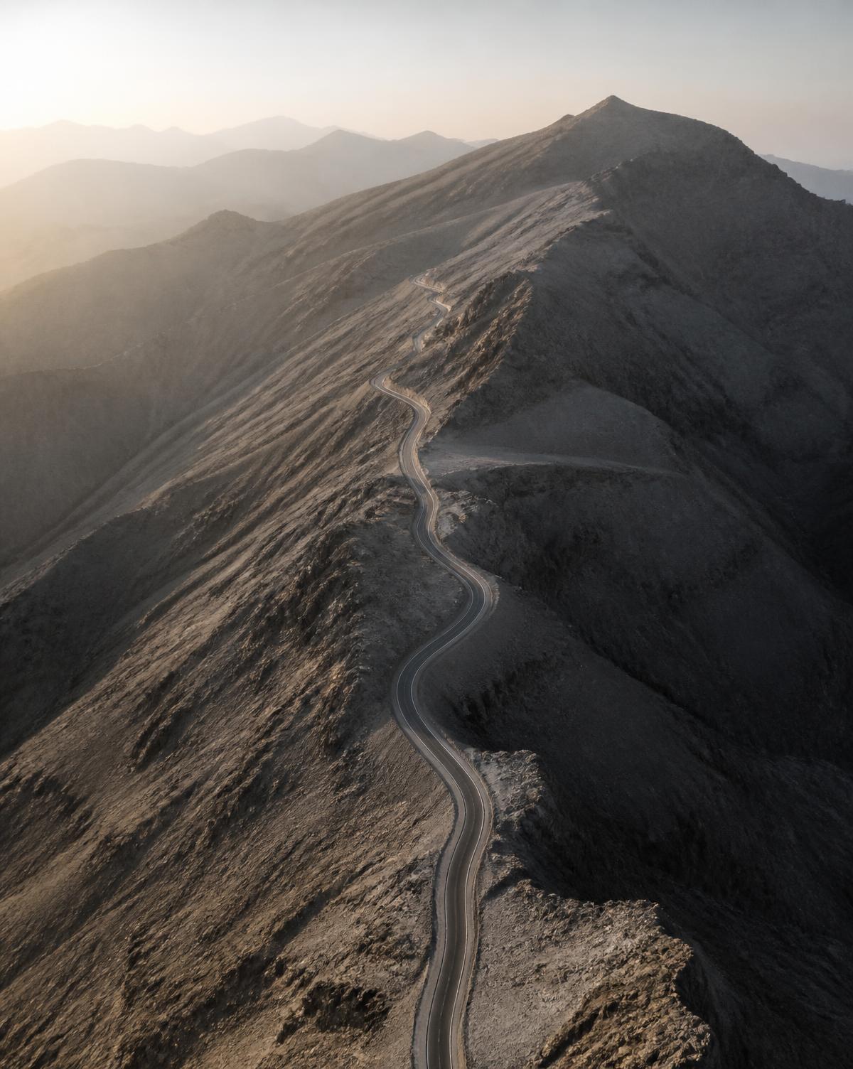 A single road climbing an arid mountain ridge